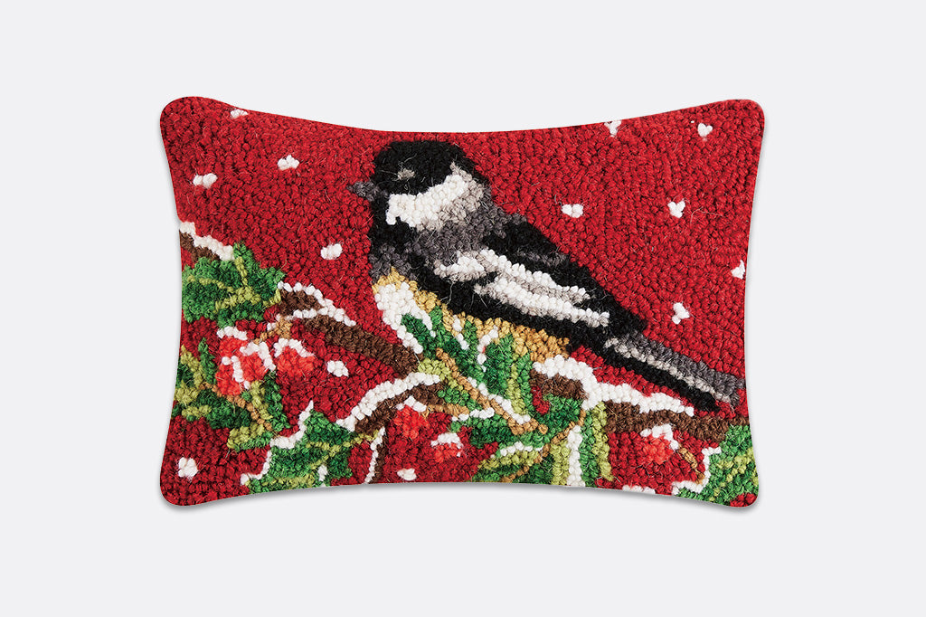 Decorative pillow with a bird design on a red background