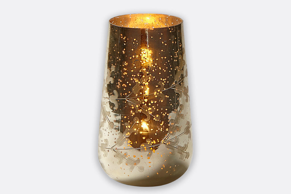 Decorative glass candle holder with a textured surface on a white background