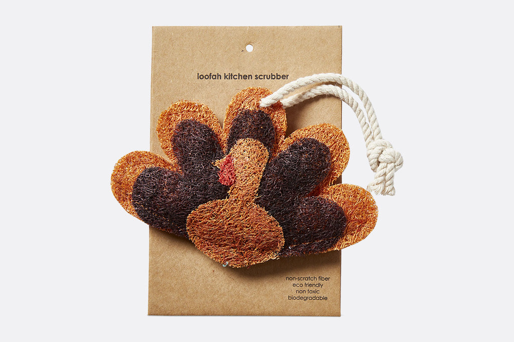 Loofah kitchen scrubber shaped like a turkey on a cardboard backing with a white background