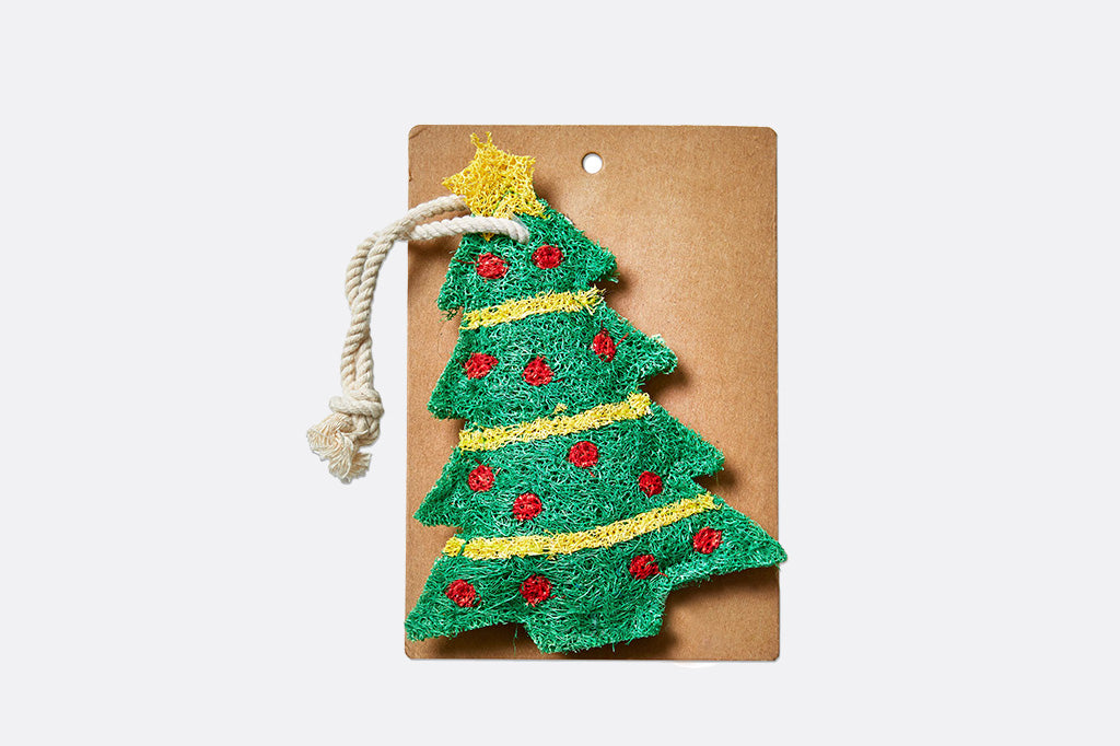 Christmas tree dish loofah on a cardboard backing with a white background