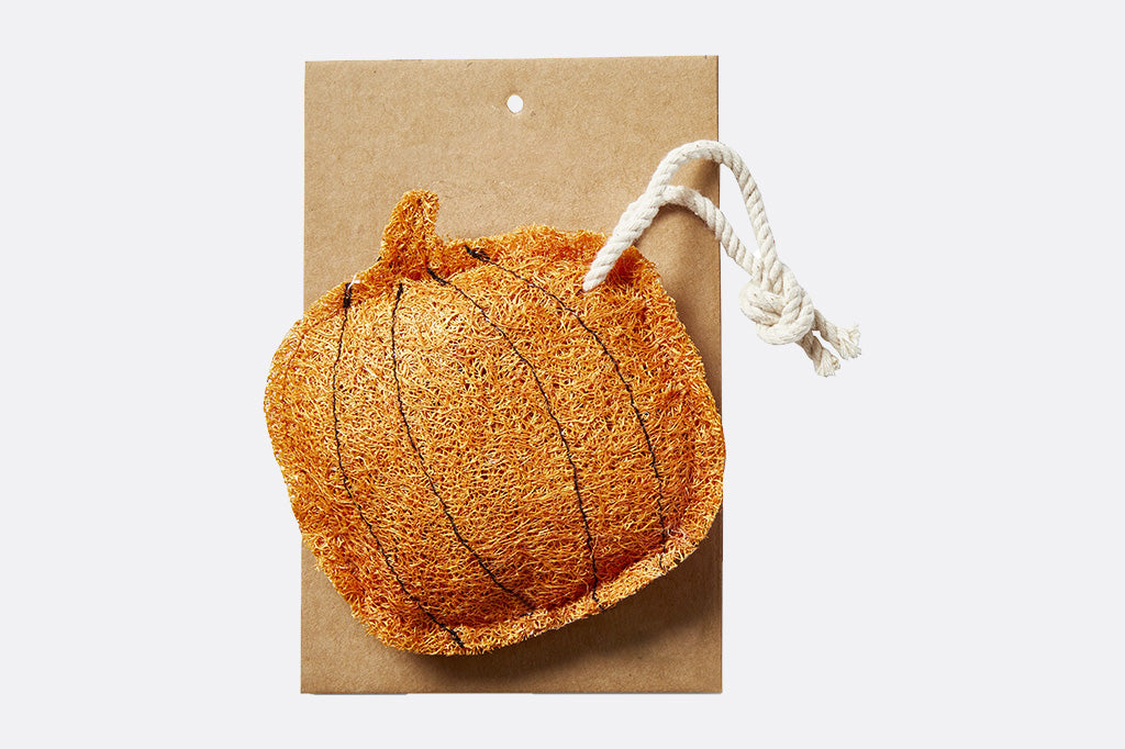 Orange pumpkin shaped dish loofah with a white rope packaged on a brown cardboard