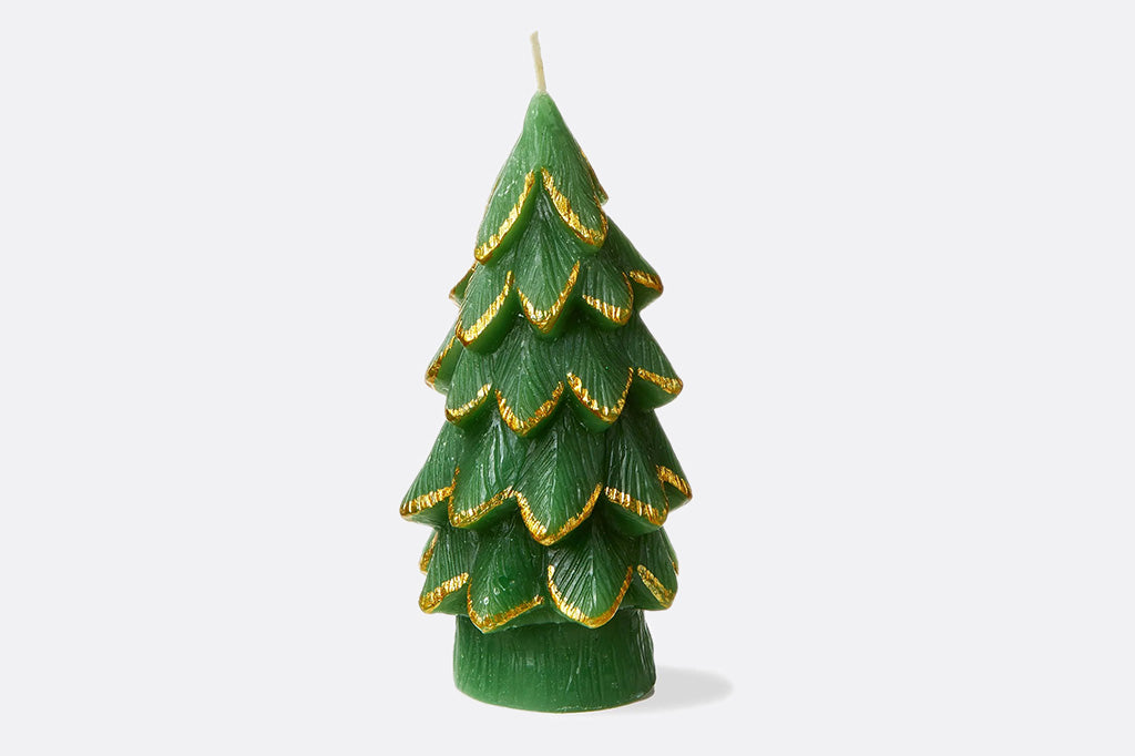 Green candle shaped like a Christmas tree with gold accents on a white background