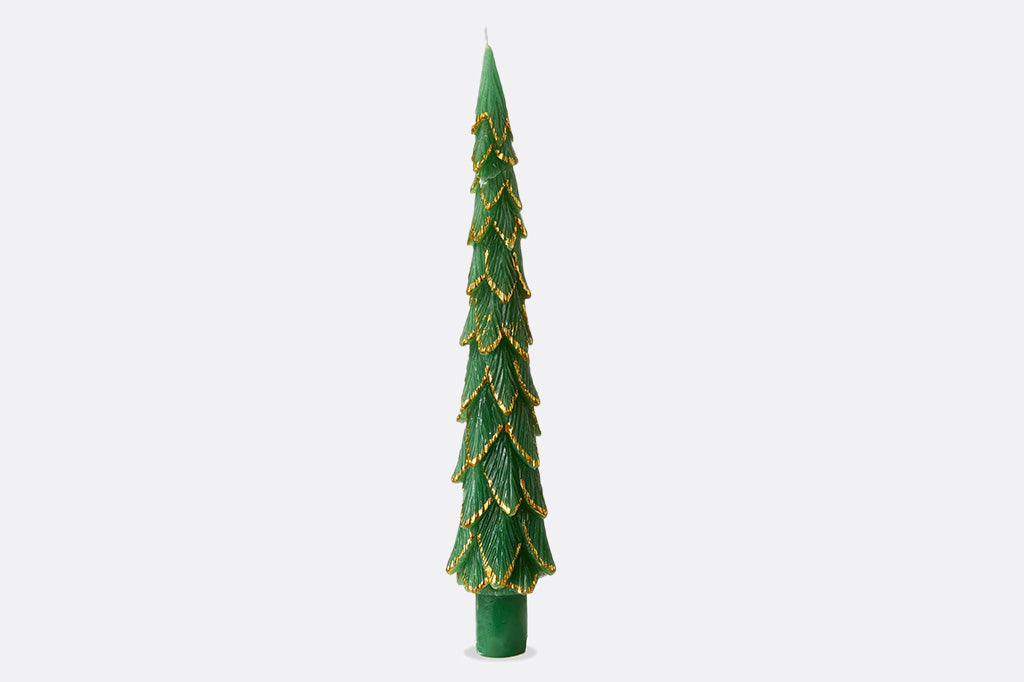 Green candle shaped like a Christmas tree with gold accents on a white background