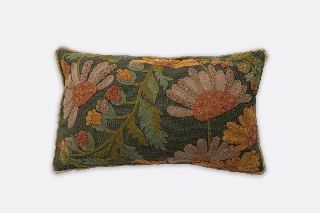 Decorative pillow with floral embroidery on a plain background