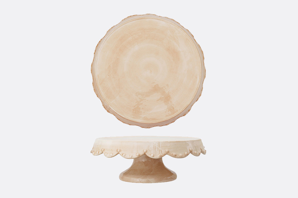 Decorative stoneware cake stand on a white background, side view and top view