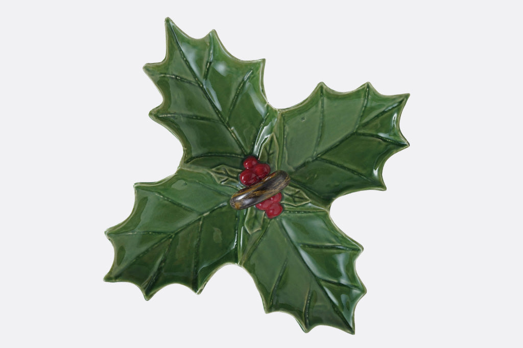 Decorative green holly leaf 4-part dish with red berries on a white background