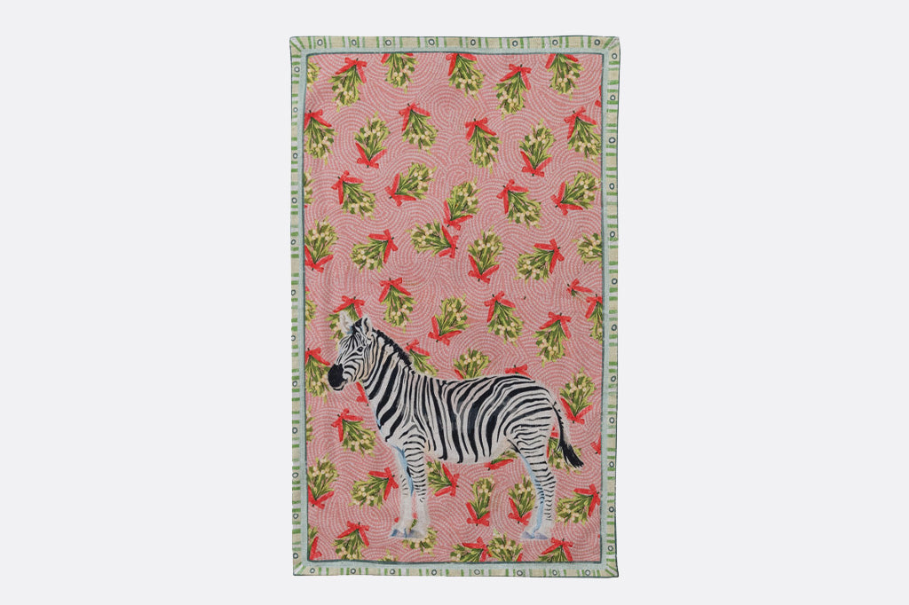 Holiday tea towel with animal illustrations and festive prints. zebra