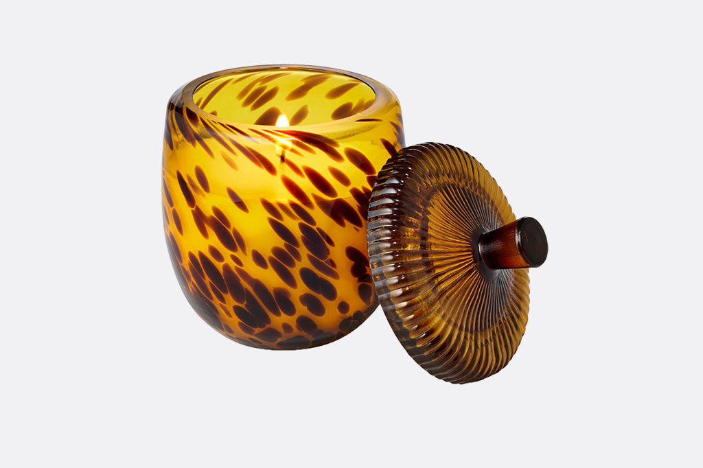 Tortoiseshell-patterned candle jar with an acorn shape lid on a white background