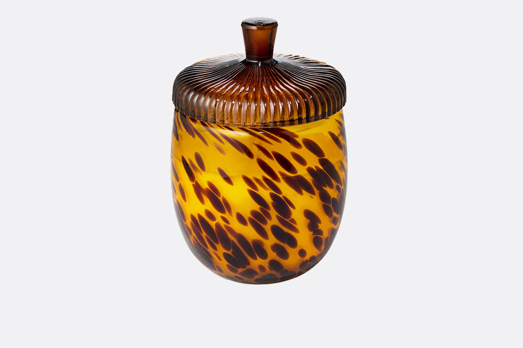 Tortoiseshell-patterned candle jar with an acorn shape lid on a white background