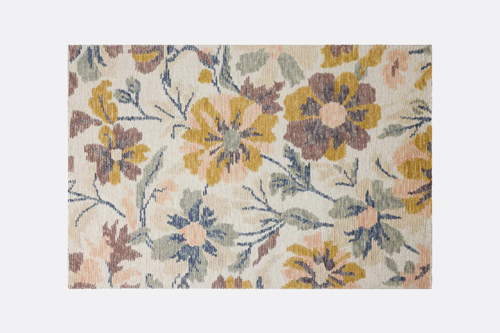 Floral patterned rug with multicolor flowers on a plain background