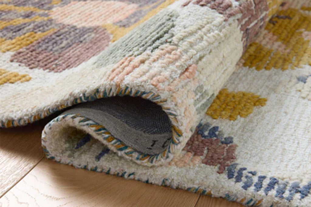 Multicolored patterned rug on a wooden floor
