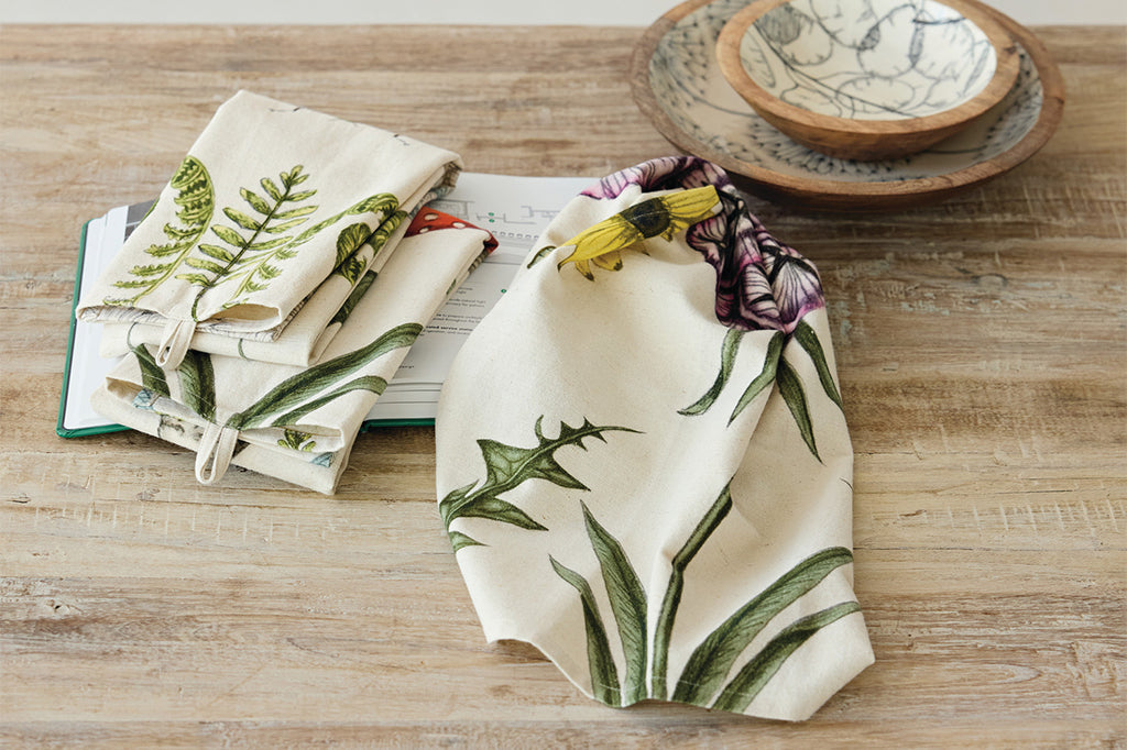 A set of 3 dish towels that have illustrations of mushrooms, butterflies, flowers, snails, and dragonflies.