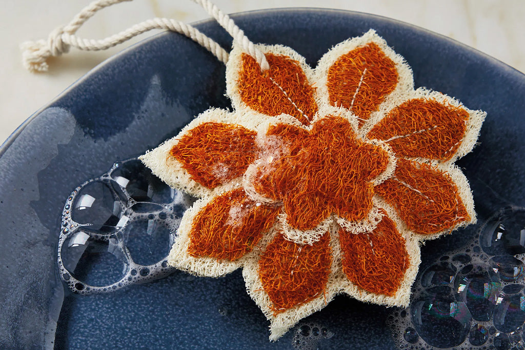 Crocheted flower pattern on a blue textured surface