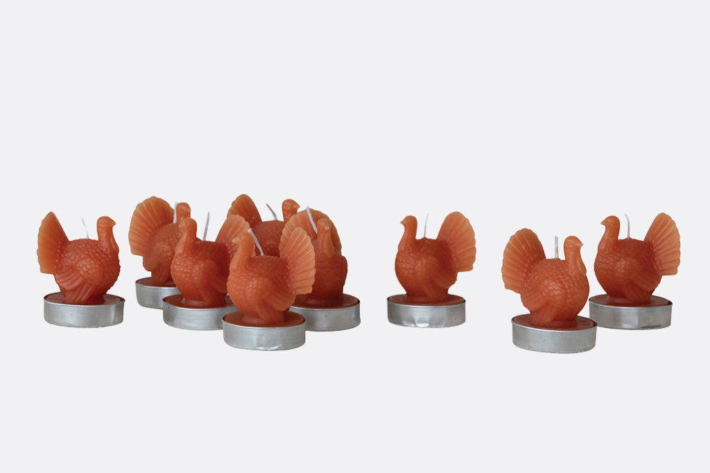 Set of turkey-shaped candles on a white background