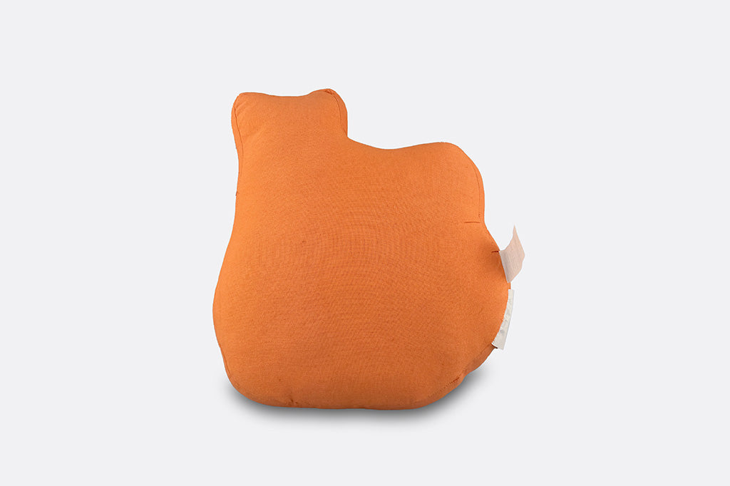 An orange jack o lantern shaped pillow with a black cat on top.