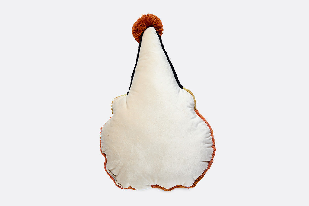 A pillow shaped like a jack-o-lantern with a party hat on.