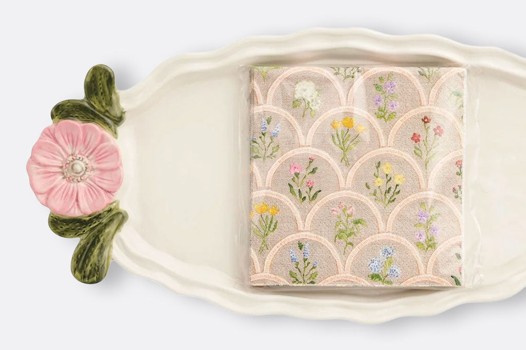 closeup detail of sculpted tray handle and paper napkin set
