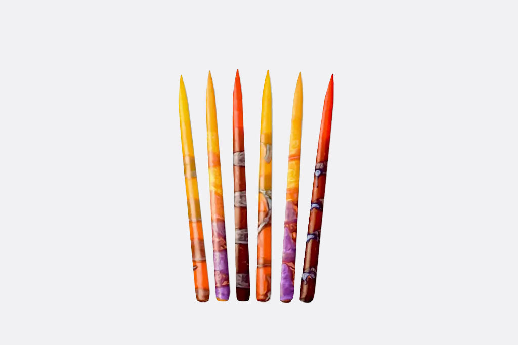 Set of colorful menorah candles in reds, oranges, and yellows on a light gray background