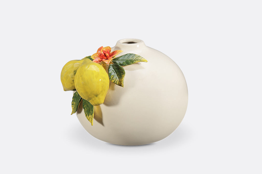 A vase with blossoming lemons.