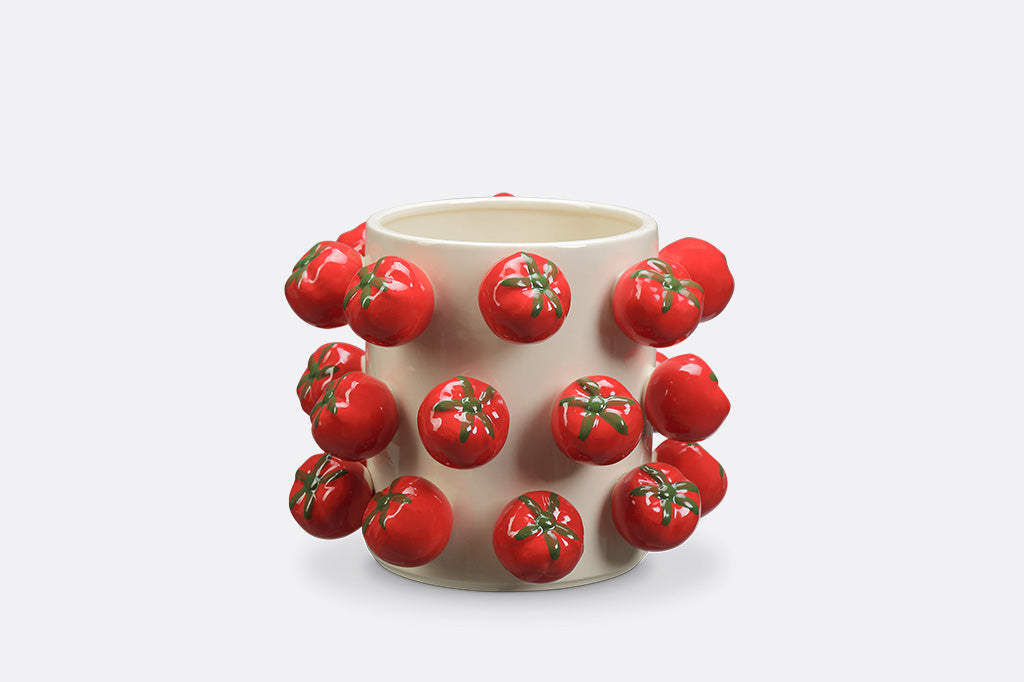 A vase with a tomato design