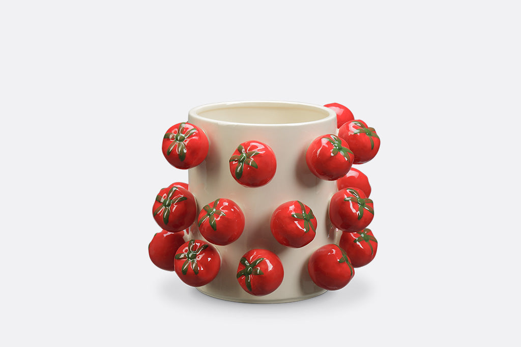 A vase with a tomato design