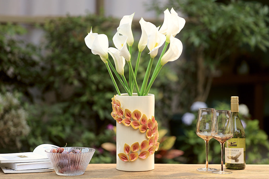 Decorative vase with white flowers on a table outdoors