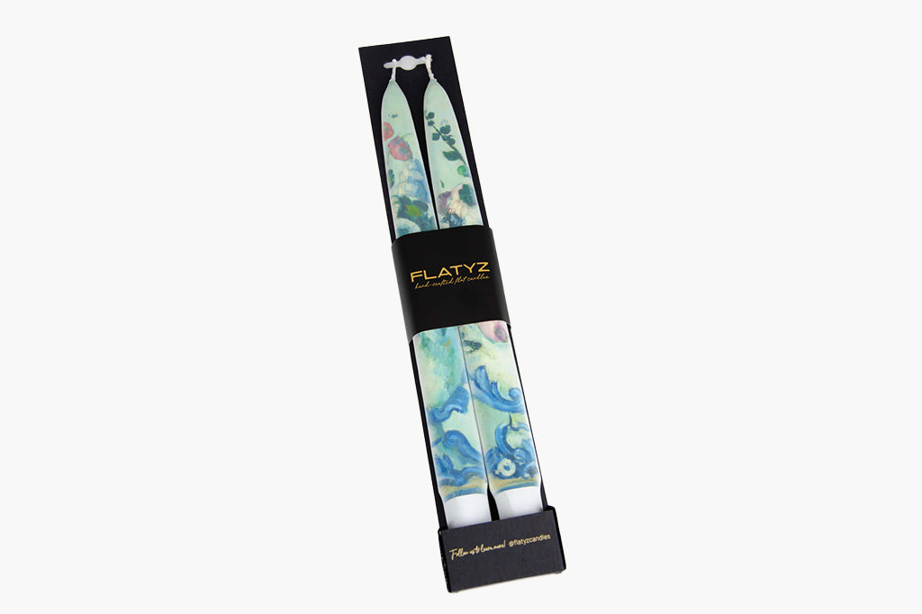 Packaged flatyz brand taper candles with floral design shown in packaging