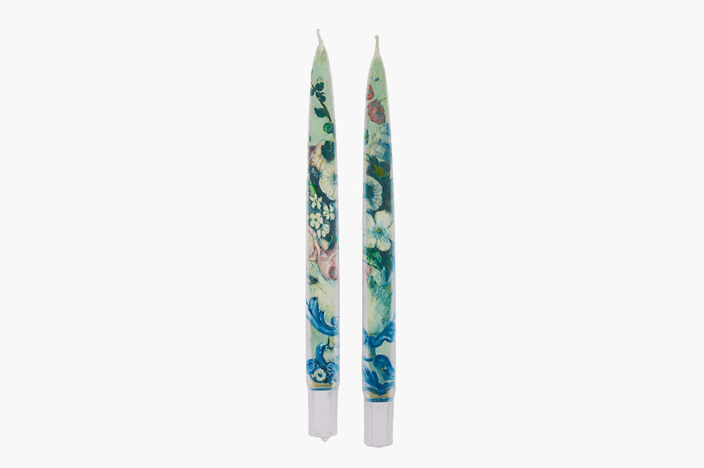 Two floral-patterned candles on a white background