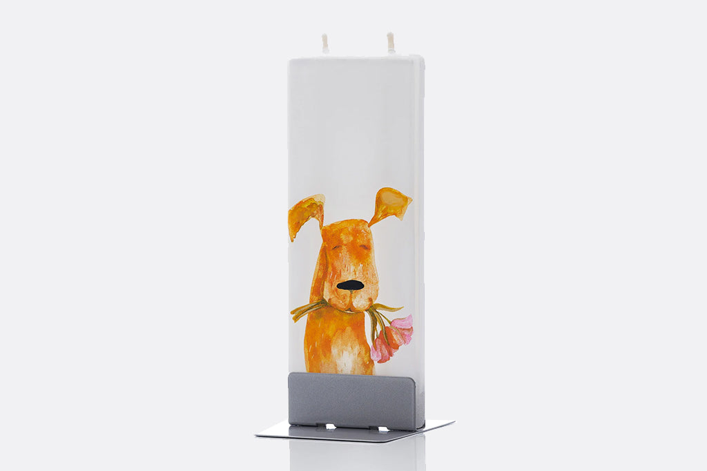 Tall flat, double wick candle on display with a dog and blossom illustration on a white background