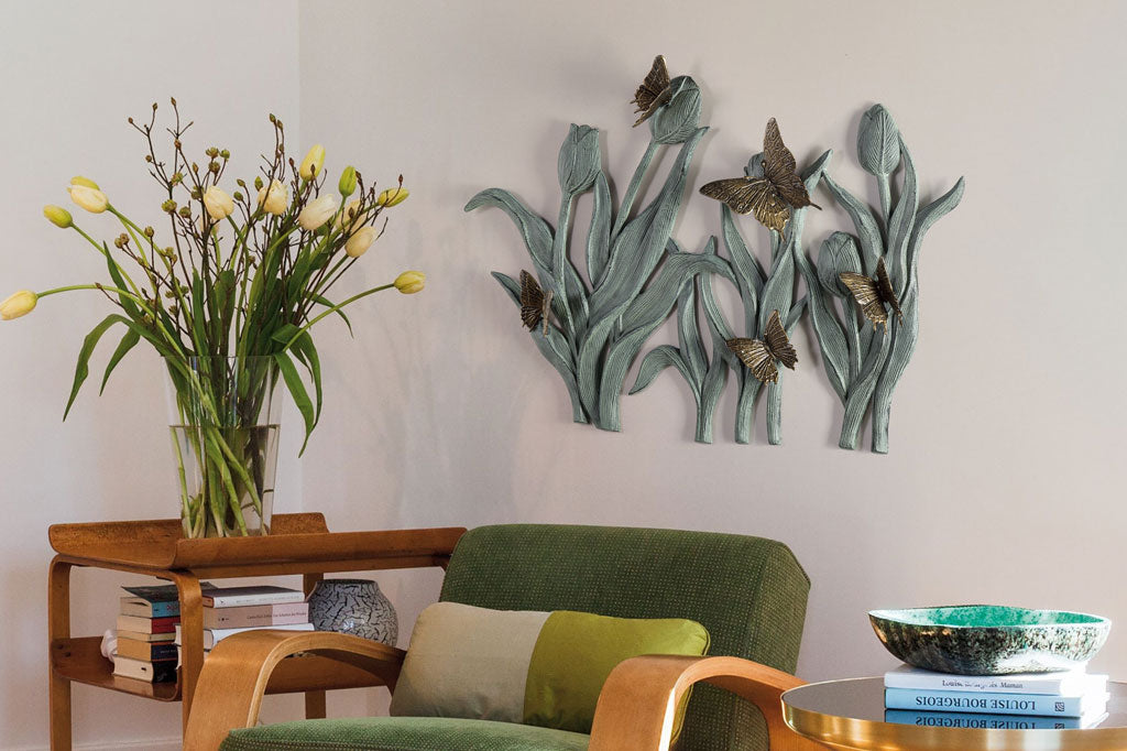 Decorative wall art with butterflies and flowers in a living room setting.