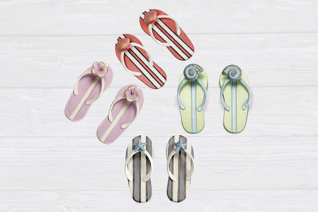 4 styles of cast metal flip-flop themed wall hook pairs shown on weathered wood background