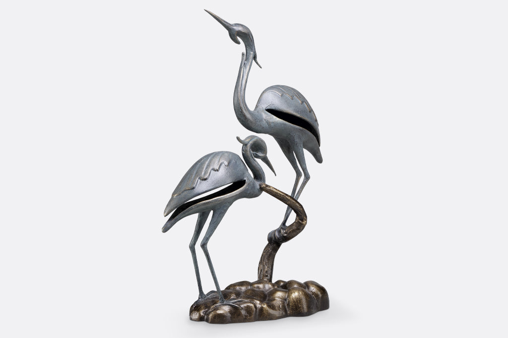 cast metal modern crane sculpture 
