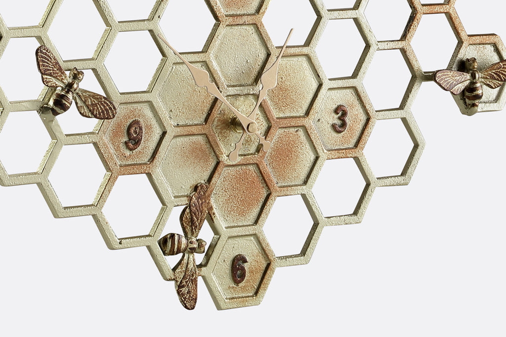 Wall clock and thermometer for outdoor or indoor. Shown on honeycomb pattern hexagon with accent sculpted bees, all in golden finish with pinky red accents