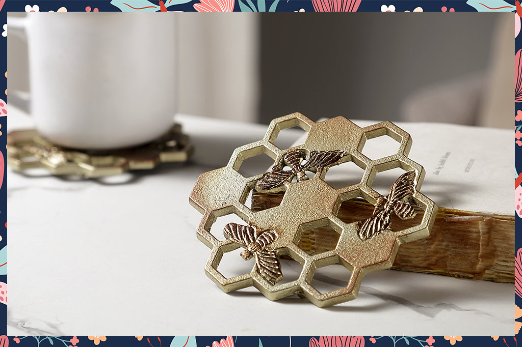 detailed shot of honeycomb and bee metal coasters