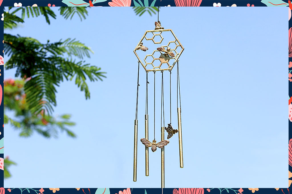 wind art showing hexagon topper with honeycomb and bee motif, 4 chimes and 2 bees suspended below