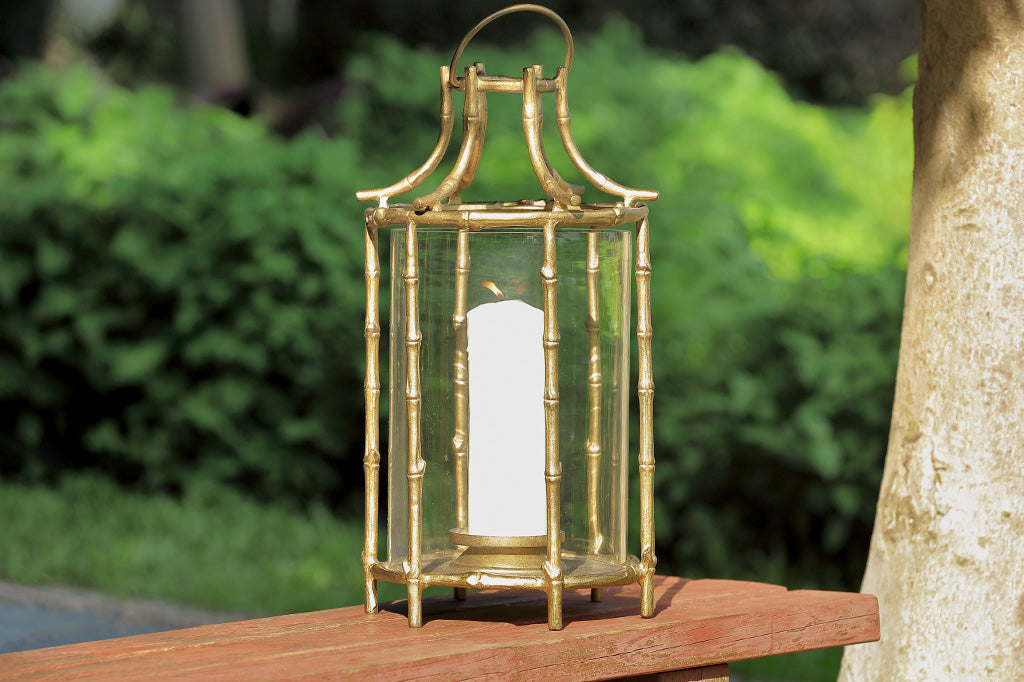 Outdoor metal lantern with bamboo details place on wood bench