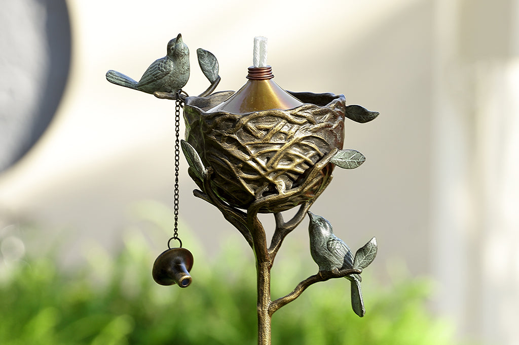 Bird's Nest cast metal Oil Torch shown unlit in garden