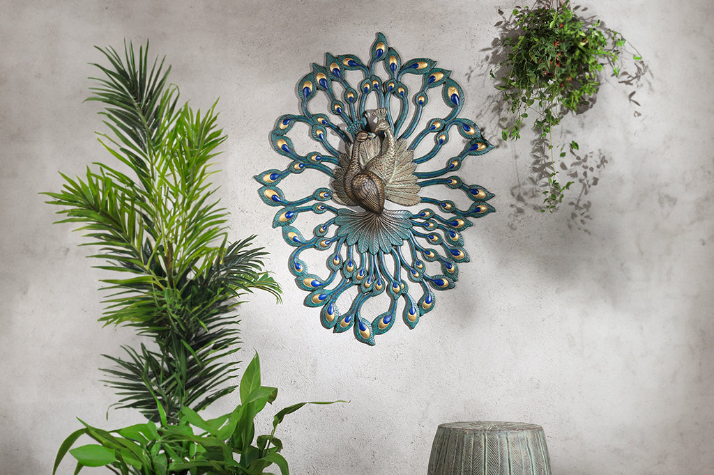 Large peacock wall art shown outdoors with plants