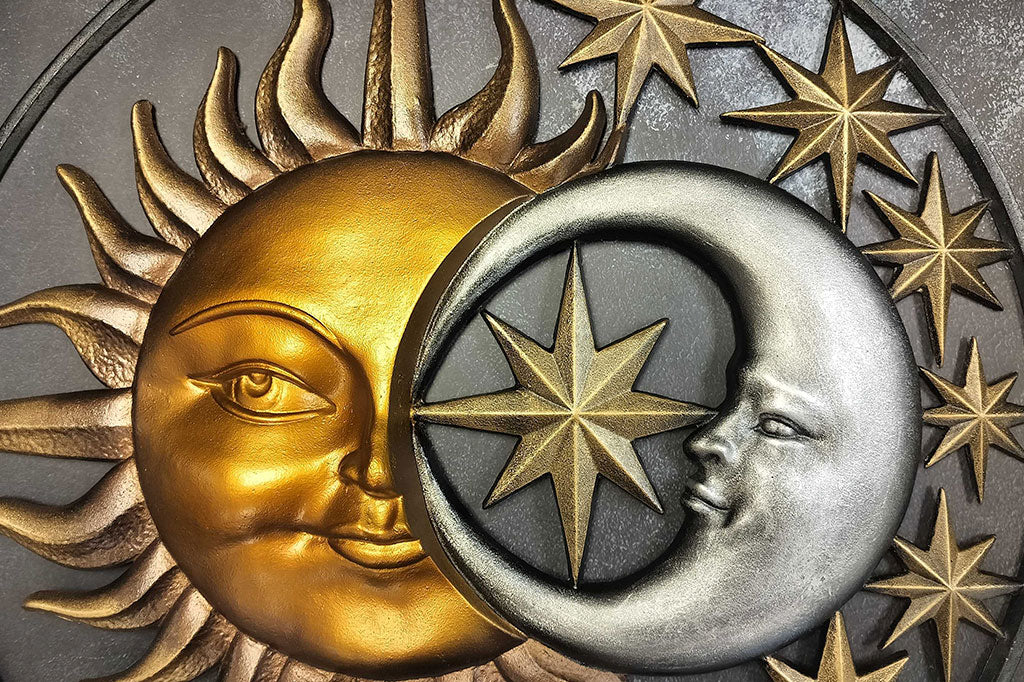 Close up view of the sun and moon relief sculpting on Stellar Skies Wall art