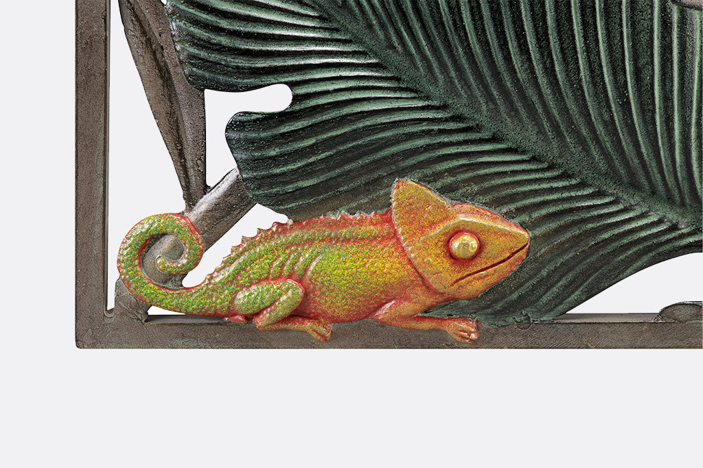 Close up of the chameleon on a large wall plaque of tropical animals