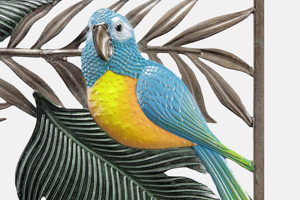 Close up of the blue and yellow parrot on a large wall plaque of tropical animals