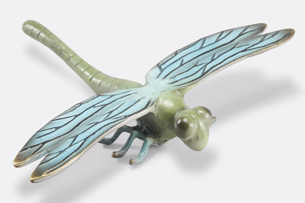 side view of the blue and green finish on a cast metal dragonfly garden sculpture