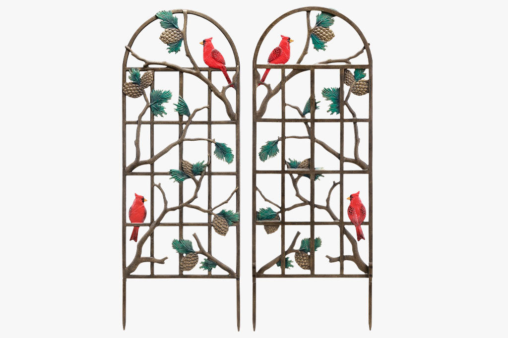 Garden trellis featuring 2 red cardinals, pine branches, and pine cones shown  with front and backs facing viewer, revealing that both sides are fully finished with bronze, reds, and green accents