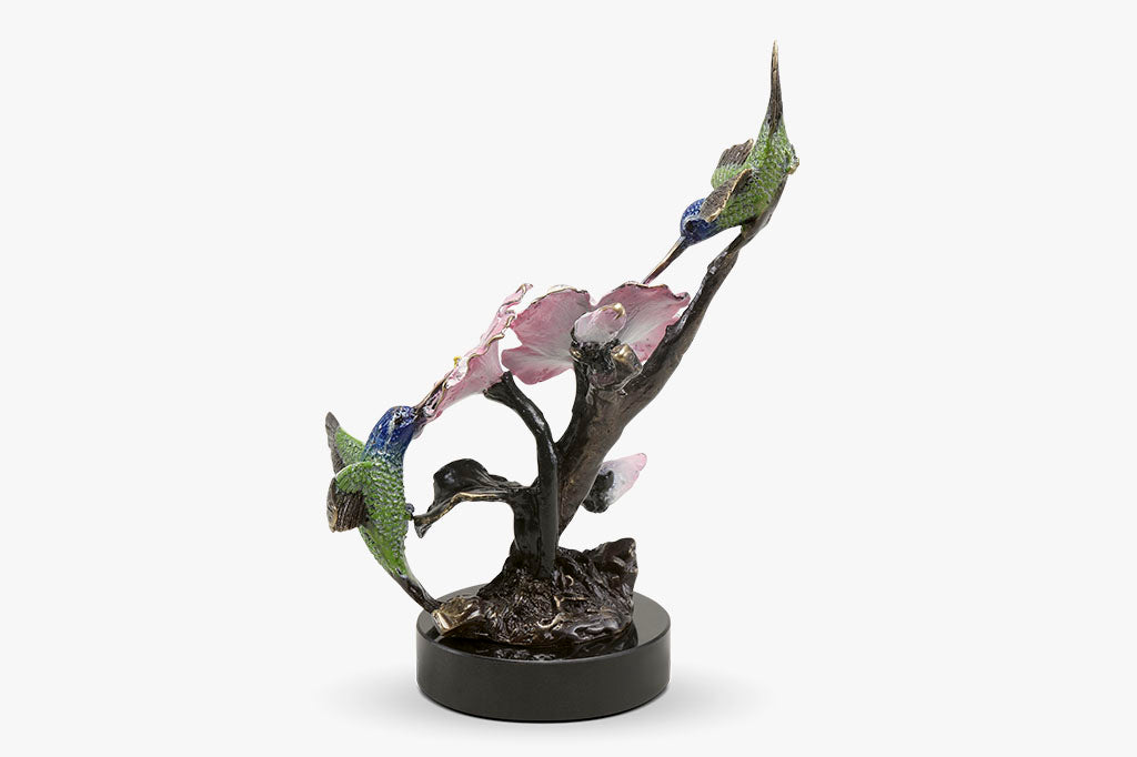 Brass hummingbird sculpture with pink blossoms, indoor sculpture