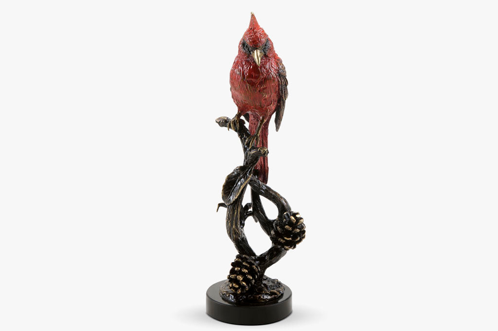 Brass sculpture of cardinal on branch, face forward