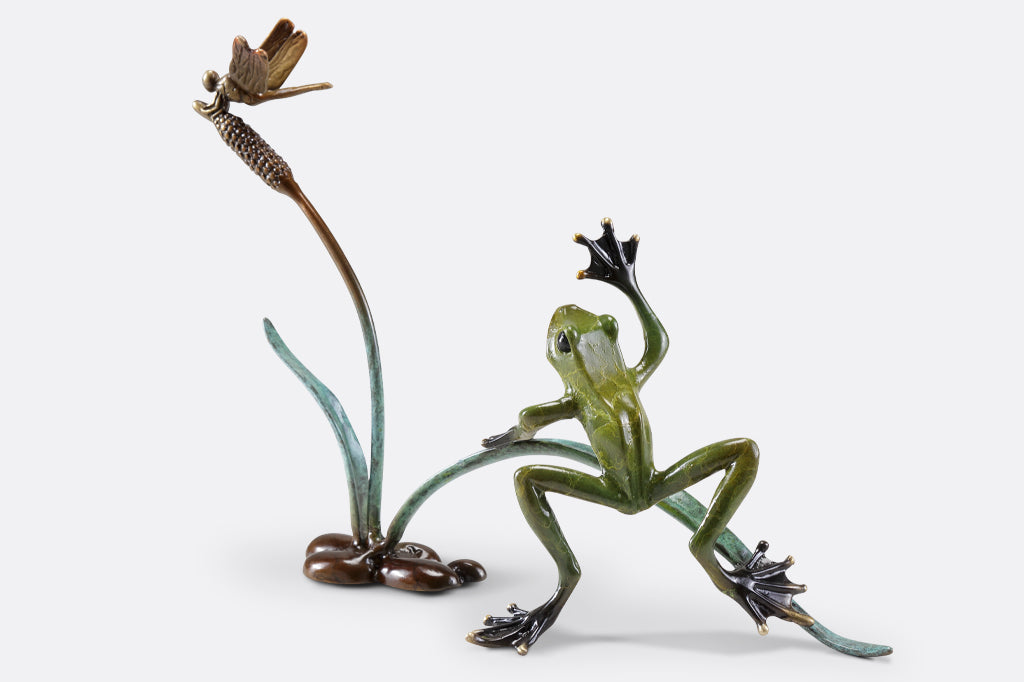 Cast metal frog and dragonfly on cattail sculpture