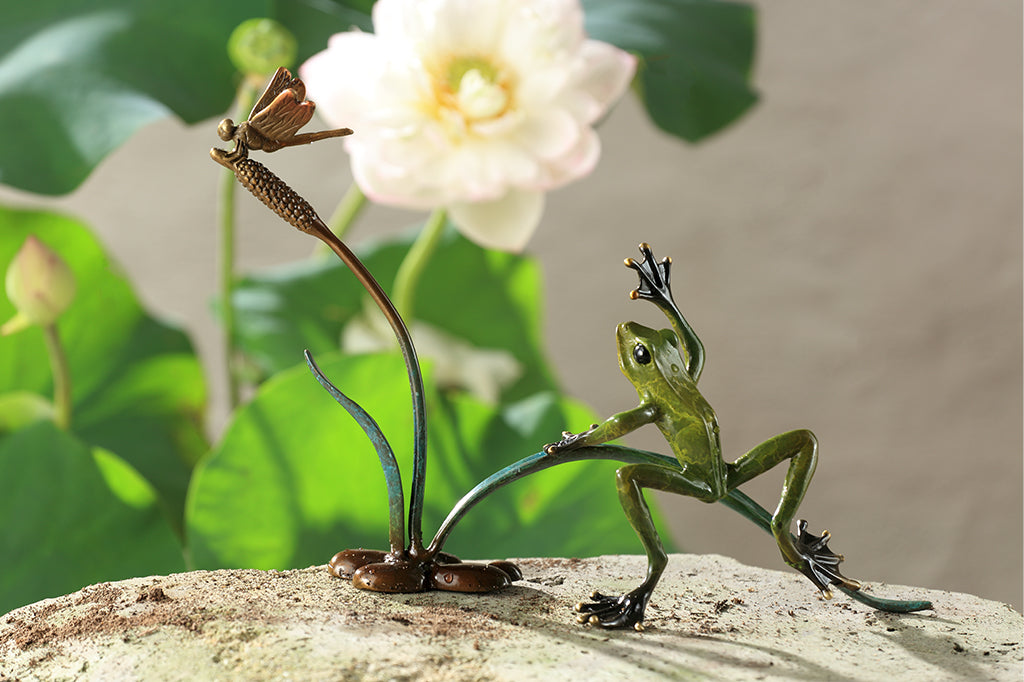 Cast metal frog and dragonfly on cattail sculpture