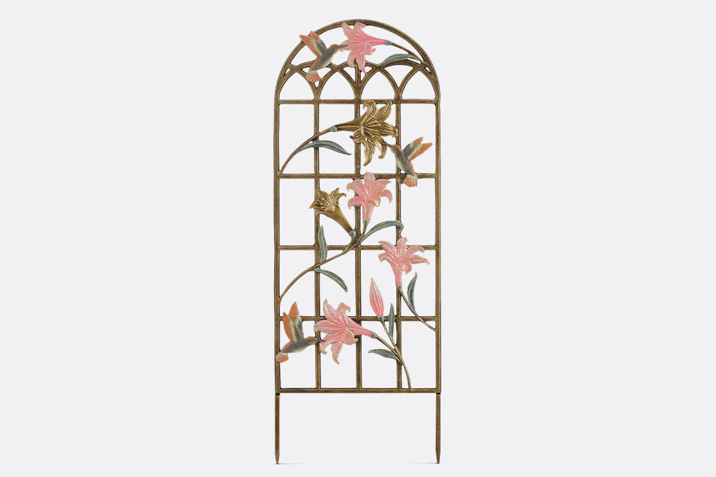 arched trellis featuring pink and gold lilies with sculpted hummingbirds at 3 blossoms