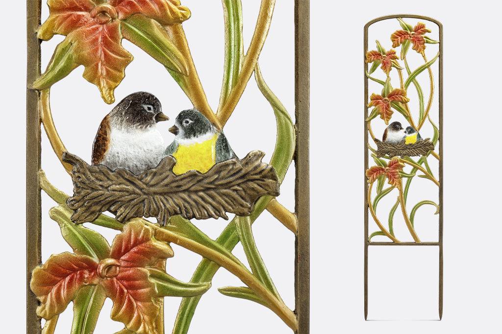 cast metal metal planter trellis, highlighting two birds in a nest surrounded by lilies  