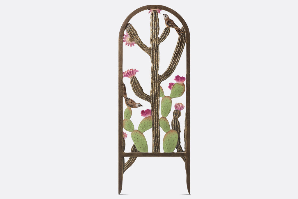 garden trellis; it features two cacti with pink blooms and cast metal birds